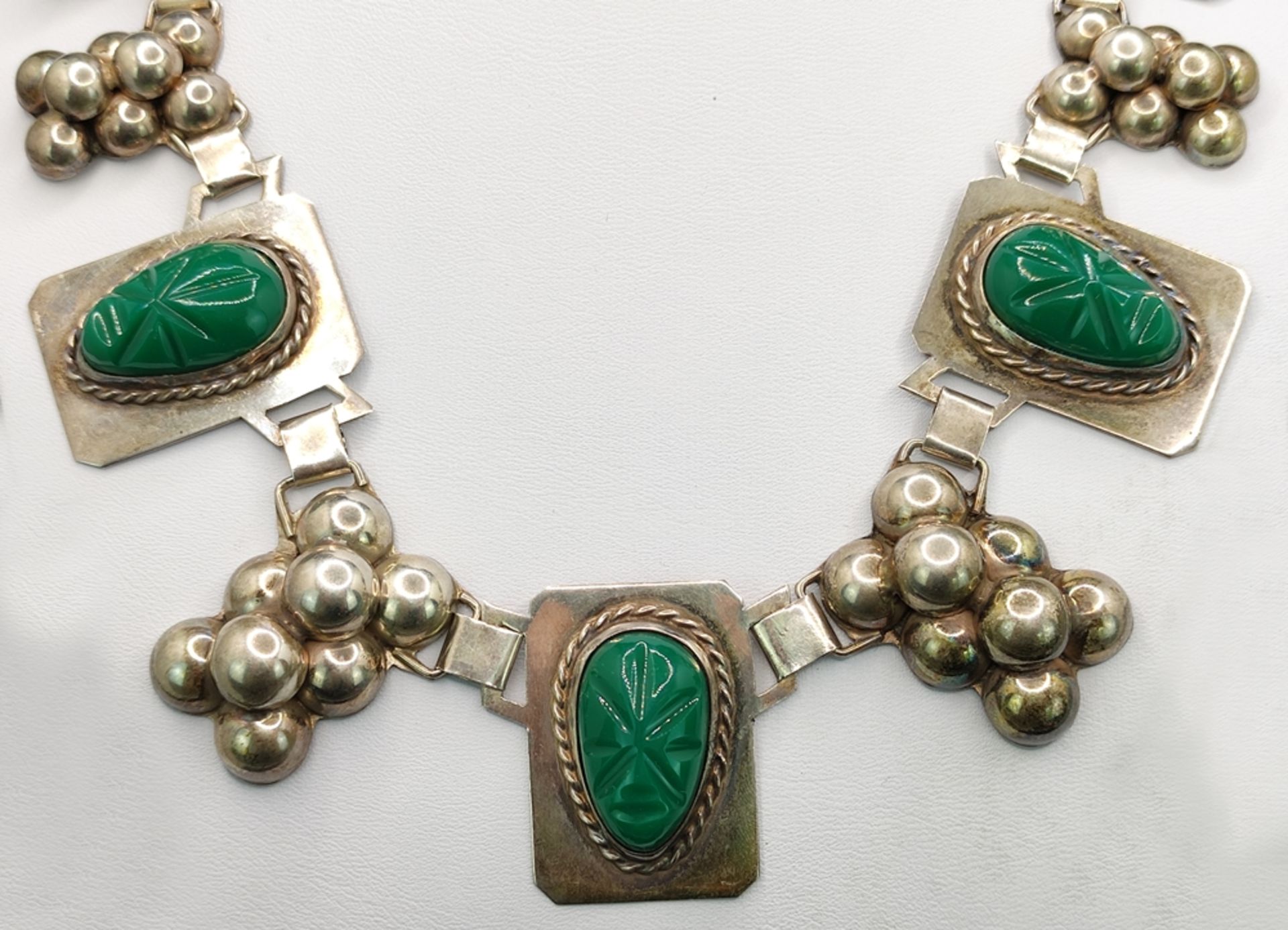 Designer necklace with aventurine, middle part with 5 hand engraved face masks of green aventurine