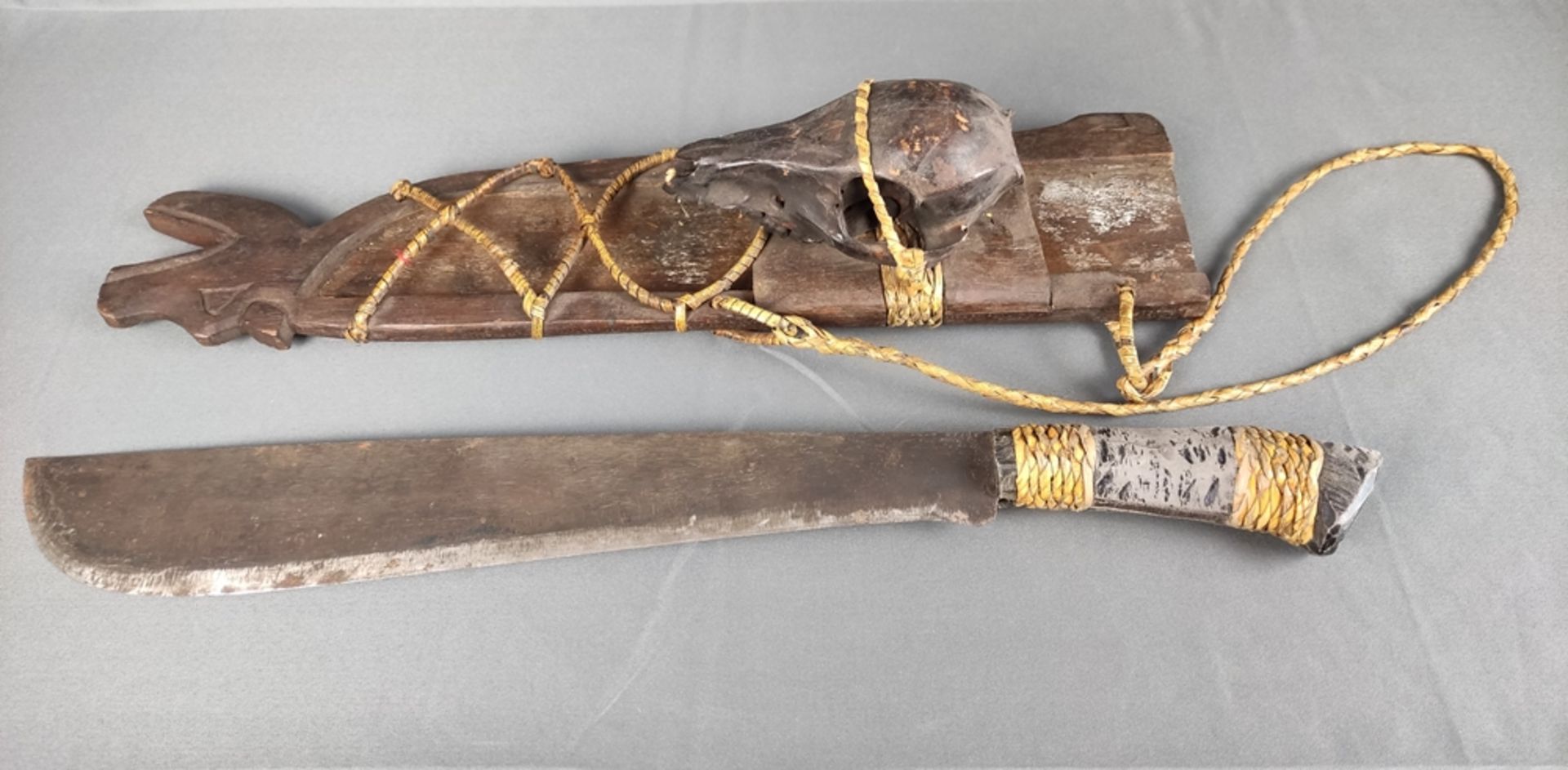 Machete, in wooden scabbard with carved animal head, mounted animal skull, brown lacquered, straw - Image 2 of 3