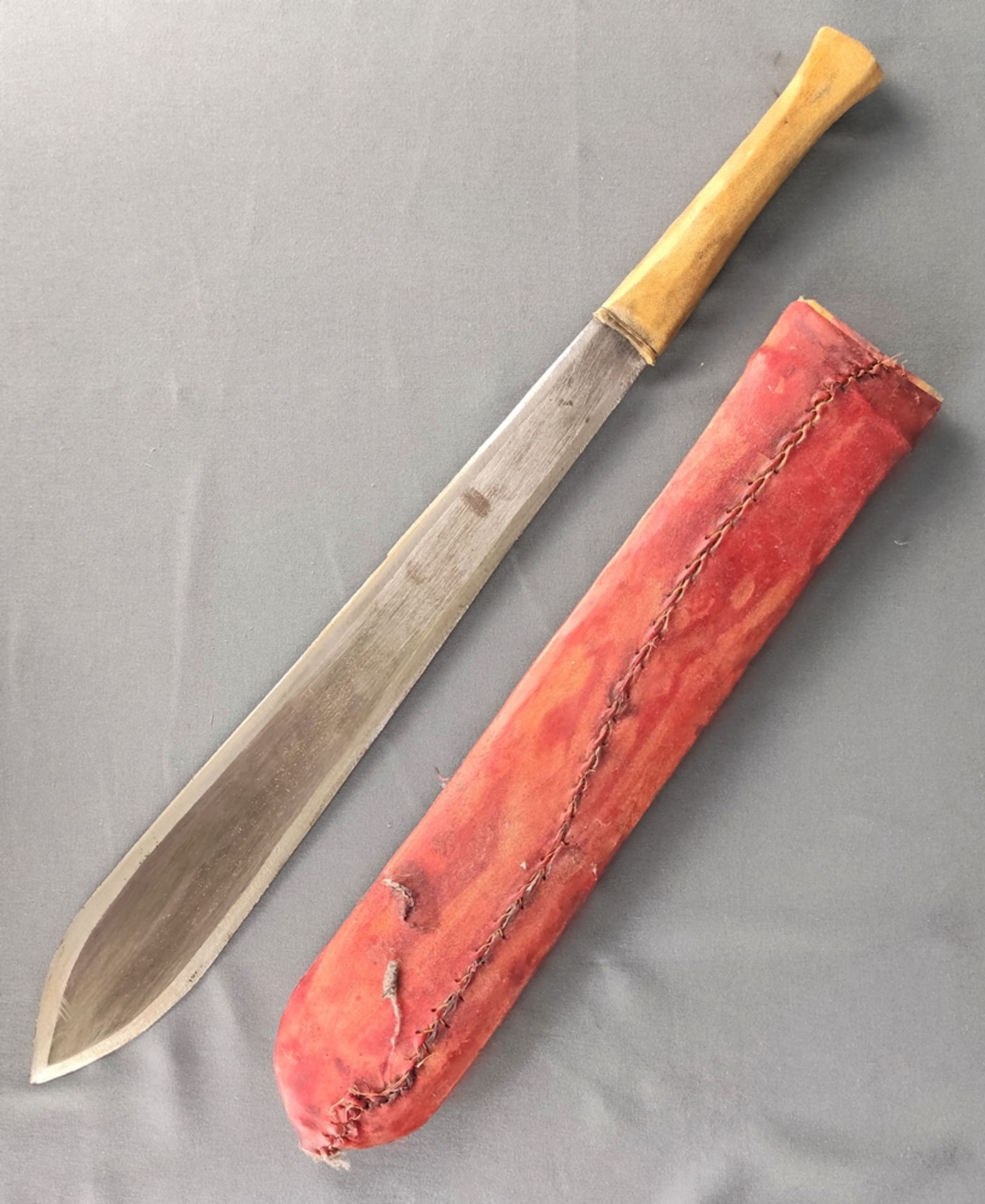 Antique bush knife, blade flared downwards, tapered, double-edged, leather handle, leather sheath,