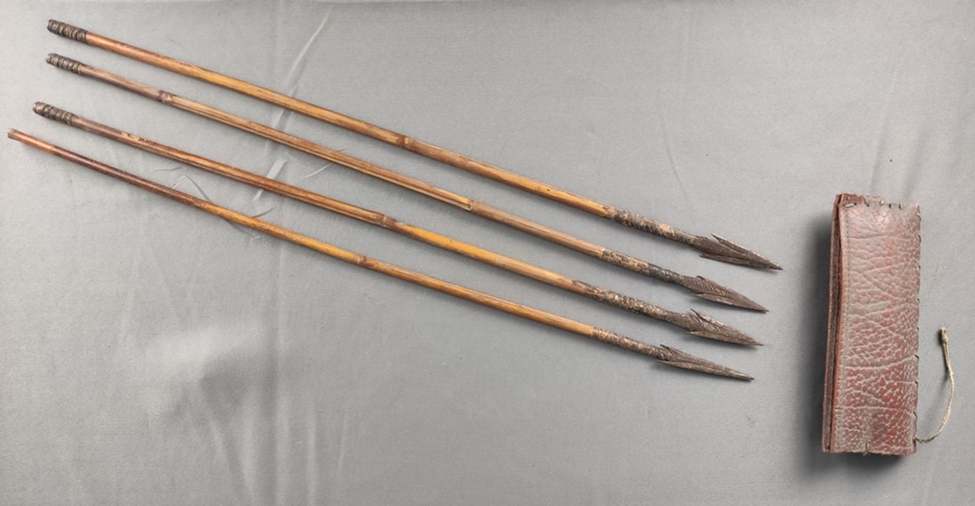 Four arrows with leather quiver, barbed iron arrowhead, cane, partly wrapped, Africa, probably