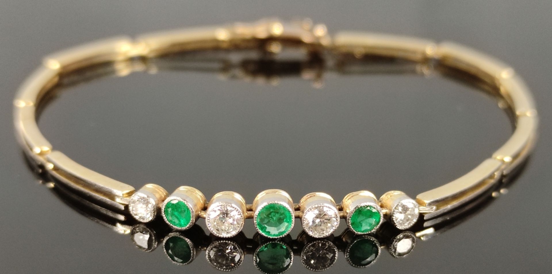 Bracelet, set with 3 emeralds and 4 diamonds, 585/14K yellow gold, pin lock clasp with safety eyele