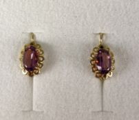 Pair of earrings, antique, hinged earwire with oval ornamental parts, these set with oval faceted a