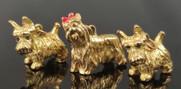 3 dog pendants, two West Iceland terrier and one Yorkshire terrier with red bow, all 333/8K yellow 