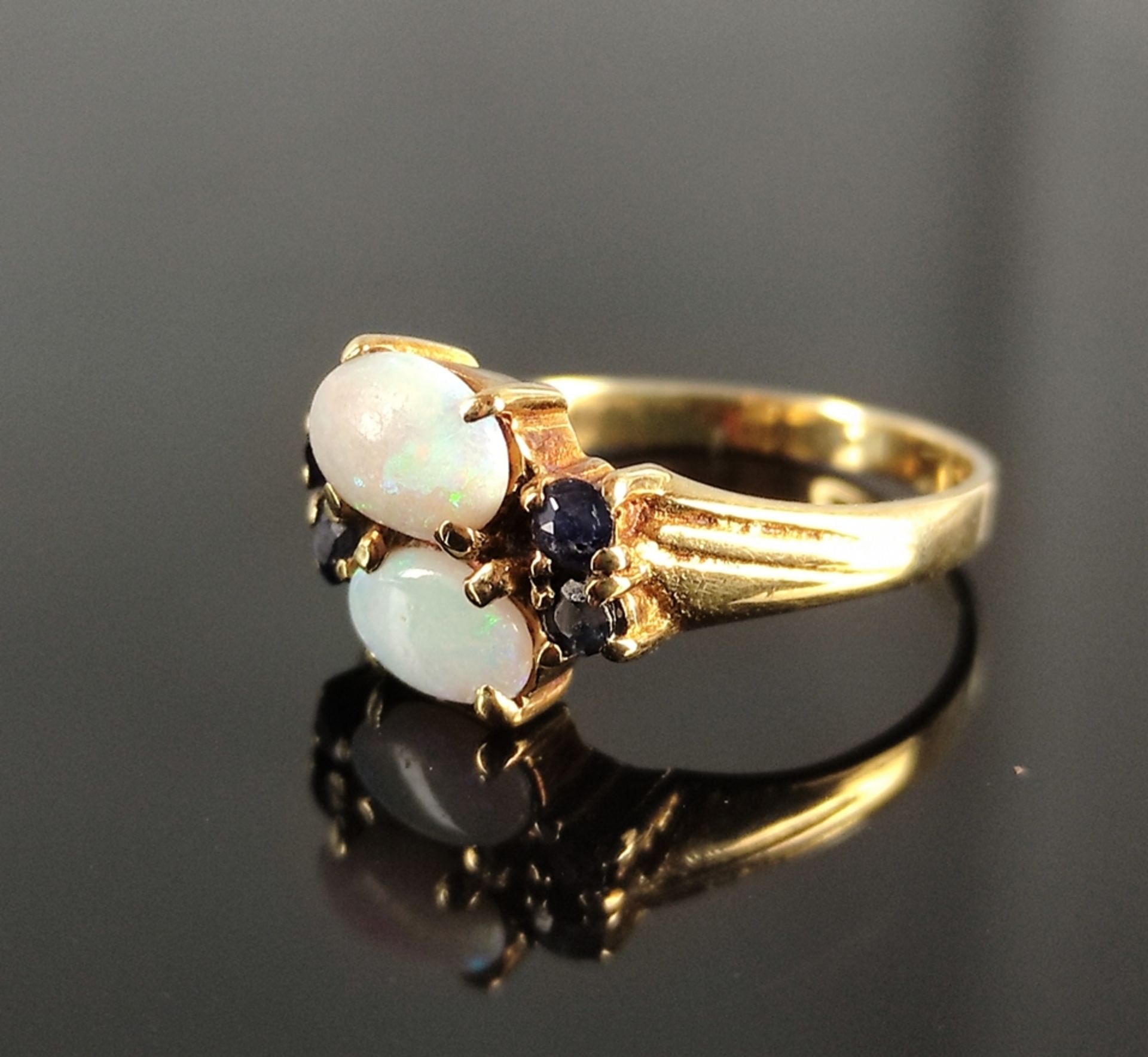 Opal ring, with two opal cabochons, around them 4 small sapphires, 585/14K yellow gold, 2,7g, ring 