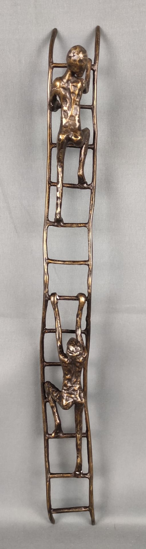 Unknown (20th century) "Climbing men", two male figures climbing up a ladder, bronze, l 56 cm