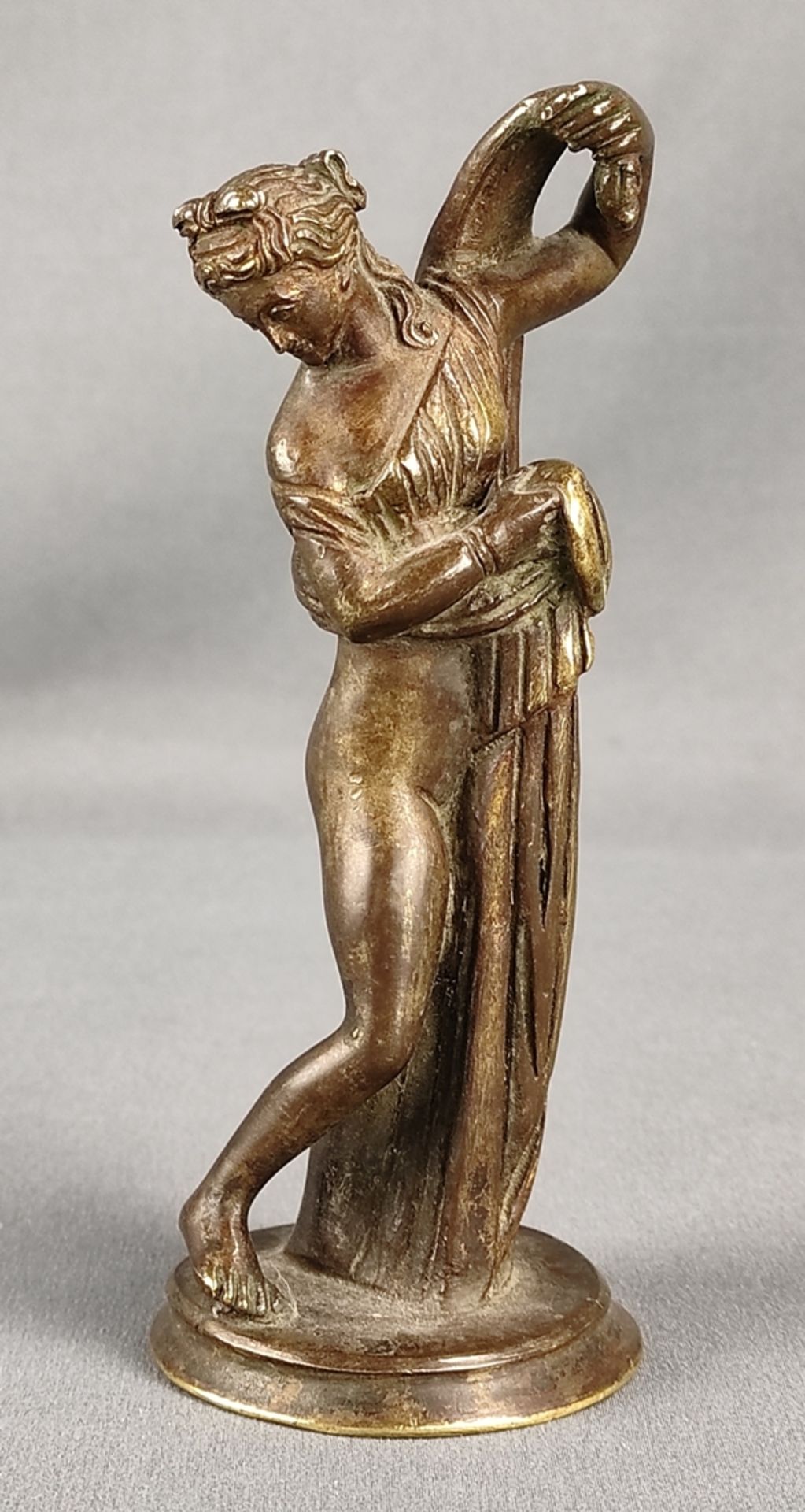 Small bronze figure, woman in contrapost, lifting her robe, height 14cm