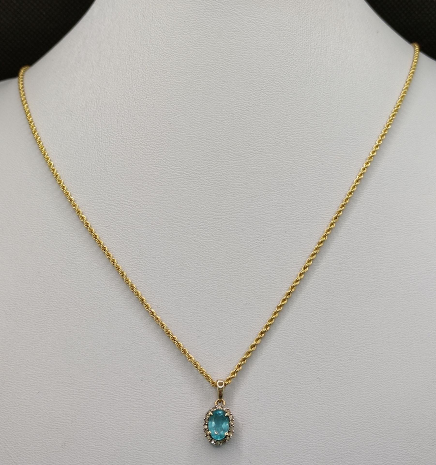 Pendant on cord chain, pendant with light blue gemstone, around it small diamonds, set in 585/14K y - Image 2 of 3