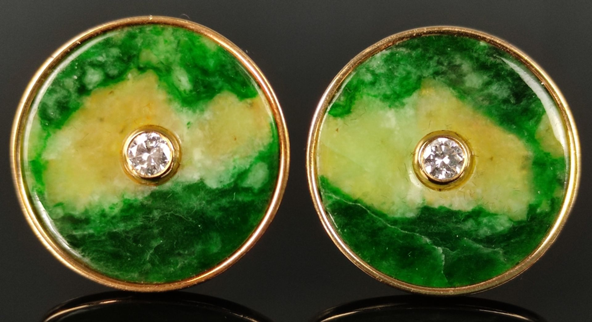 Pair of earrings, discs of jadeite, each centered with a brilliant-cut diamond, together around 0.4