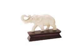 Small elephant on wooden base