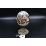 Handpainted vintage ostrich egg with brass stand, depicting a scene of "Woodbridge" and a
