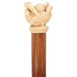 A LATE VICTORIAN/EDWARDIAN UMBRELLA, the ivory pommel in the form of three entwined pelicans,