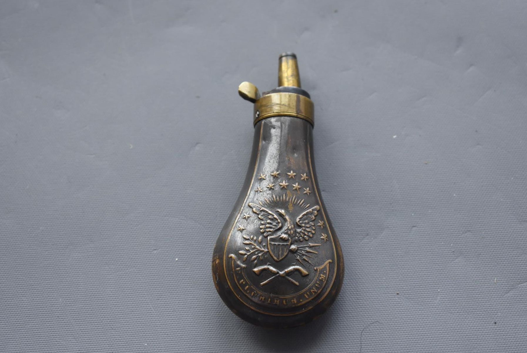 AN EMBOSSED COPPER POWDER FLASK, the lacquered copper body decorated with, stars, an eagle and - Image 2 of 7