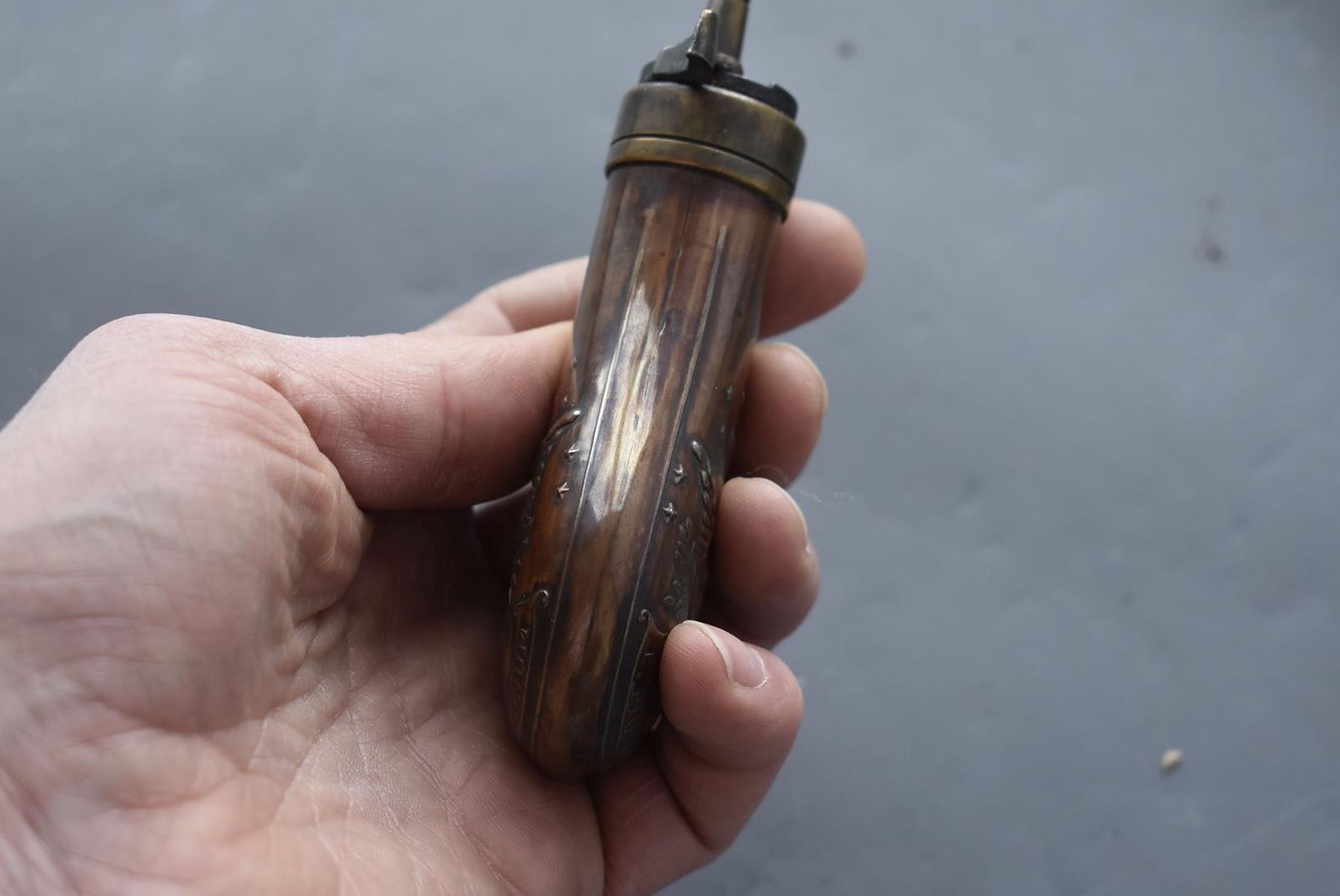 AN EMBOSSED COPPER POWDER FLASK, the lacquered copper body decorated with, stars, an eagle and - Image 7 of 8