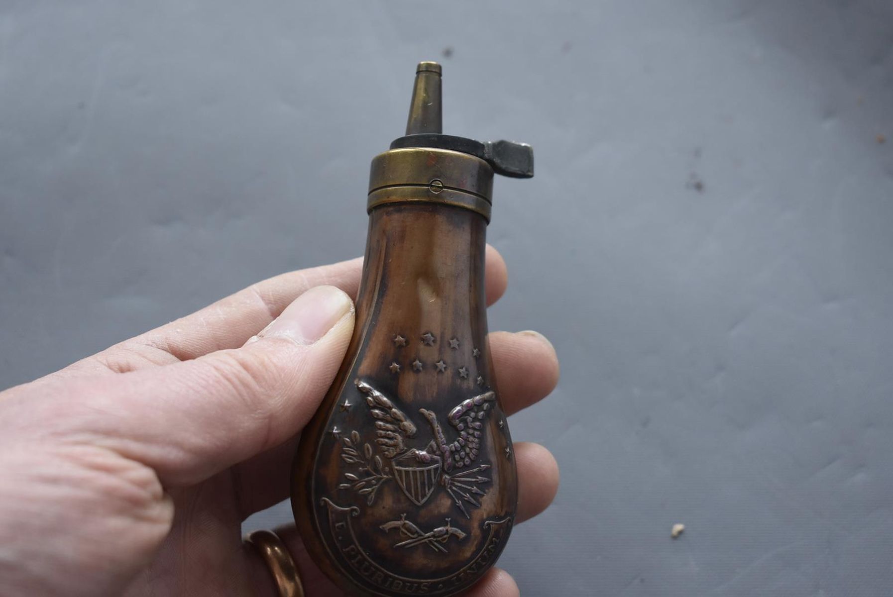 AN EMBOSSED COPPER POWDER FLASK, the lacquered copper body decorated with, stars, an eagle and - Image 4 of 8