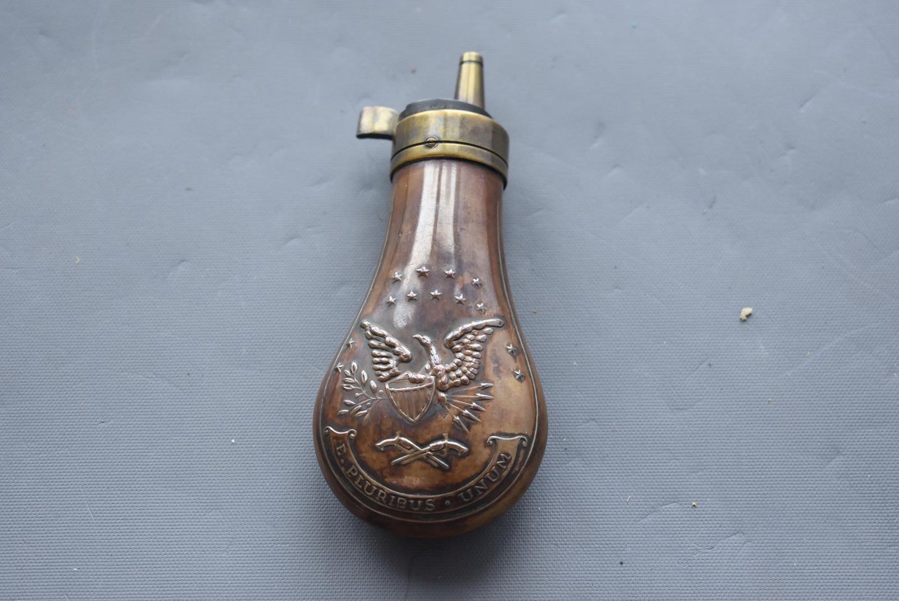 AN EMBOSSED COPPER POWDER FLASK, the lacquered copper body decorated with, stars, an eagle and - Image 2 of 8