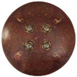 AN 18TH CENTURY MUGHAL INDIAN PAINTED LACQUERED SHIELD, 48cm diameter body decorated with four