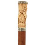 AN EARLY VICTORIAN ROMANTIC WALKING CANE, the ivory pommel intricately carved over all with acanthus