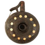 A 17TH CENTURY DUTCH OR GERMAN CIRCULAR PRIMING FLASK, the ring turned wooden body set with circular