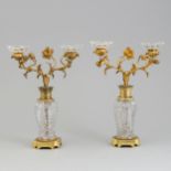 Pair of gilded brass-bronze candlesticks "Flowers" on crystal columns.