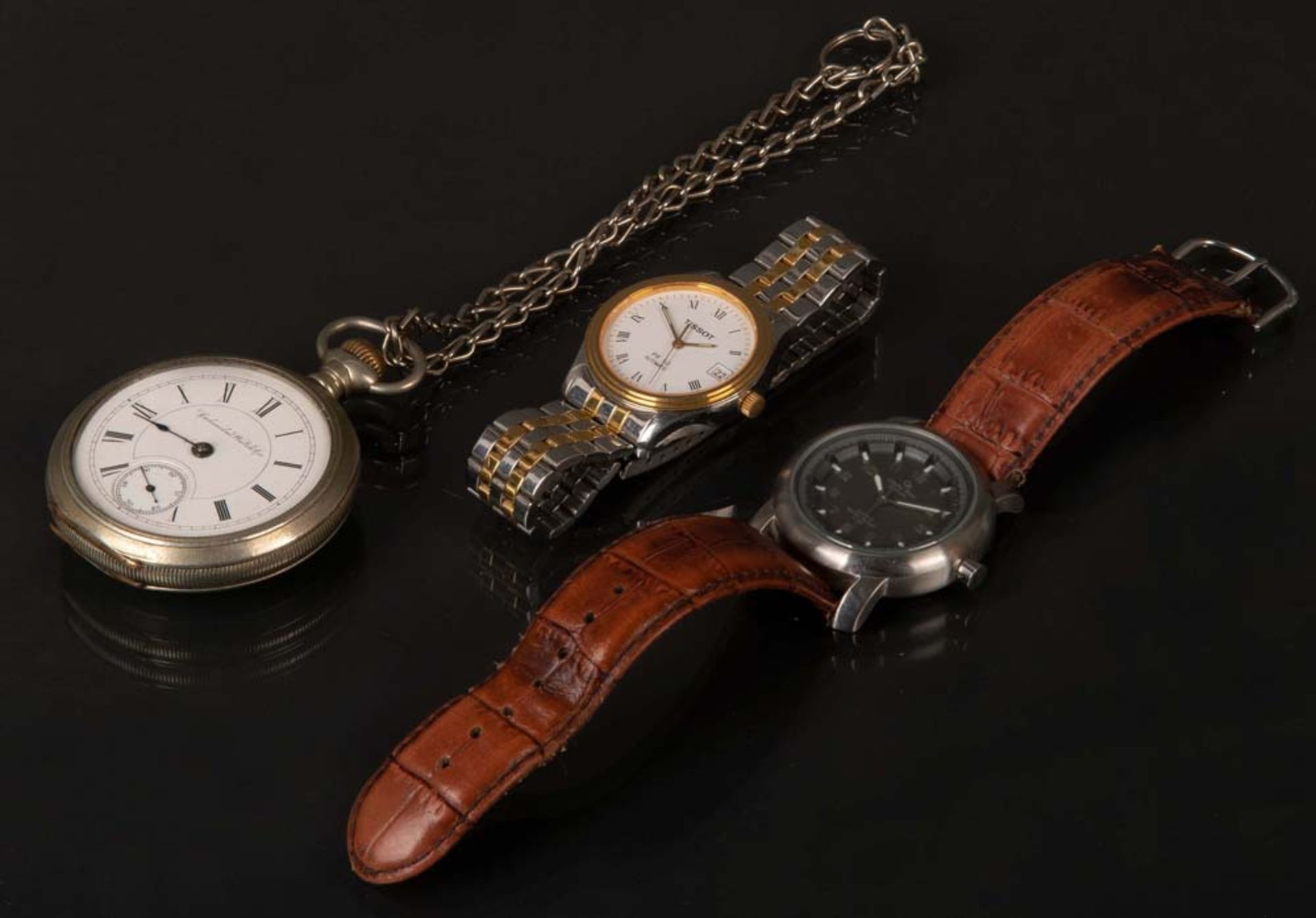 Herrentaschenuhr, Marke „Columbus Watch & Co“, 19./20. Jh., und zwei Armbanduhren, Marke „Tissot“,