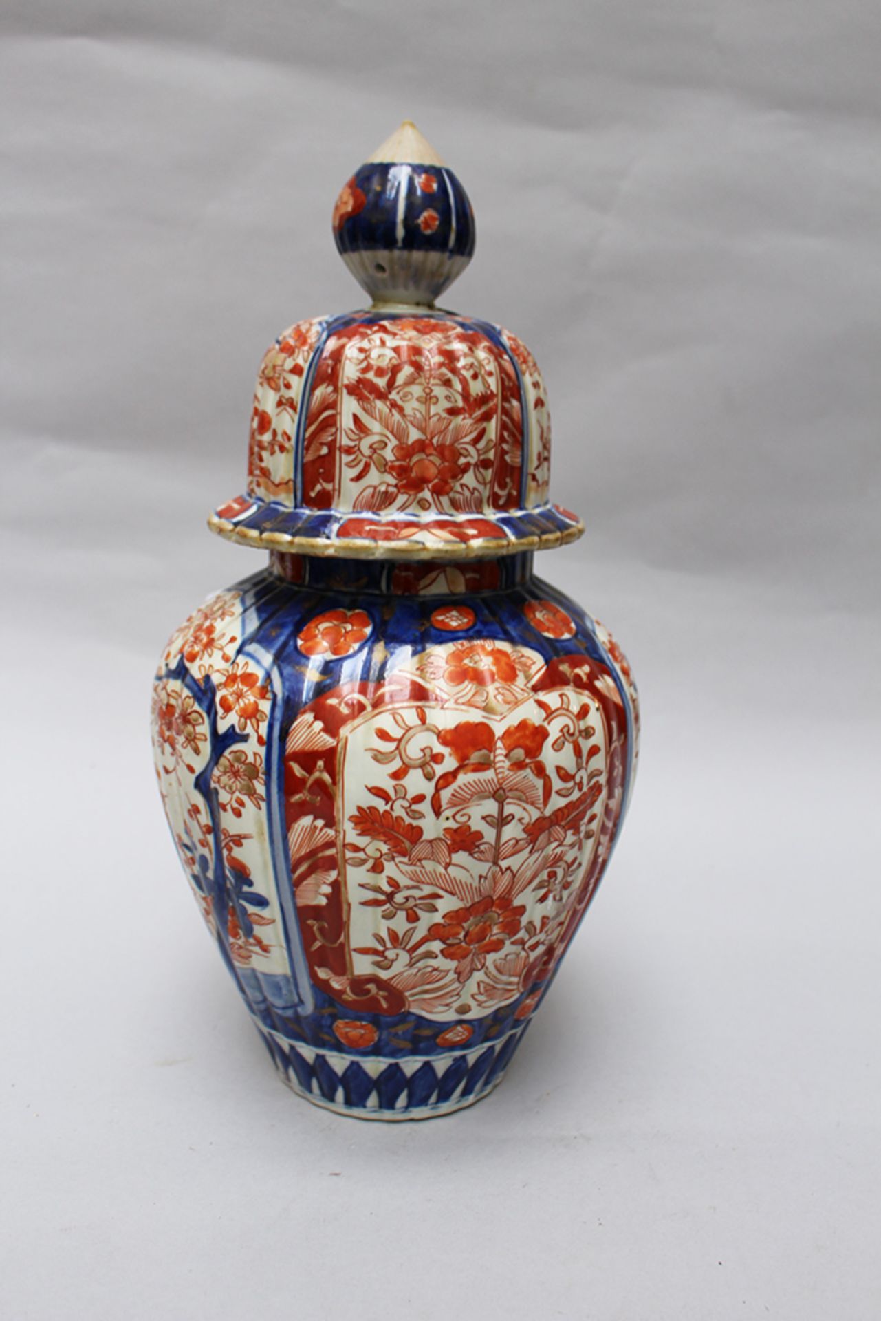 Imari Vase , fluted round decorations, painted in red and blue on white ground , glazed 19th