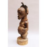 African Tribal Art sculpture of a standing female on naturalistic integrated base , wood carved with