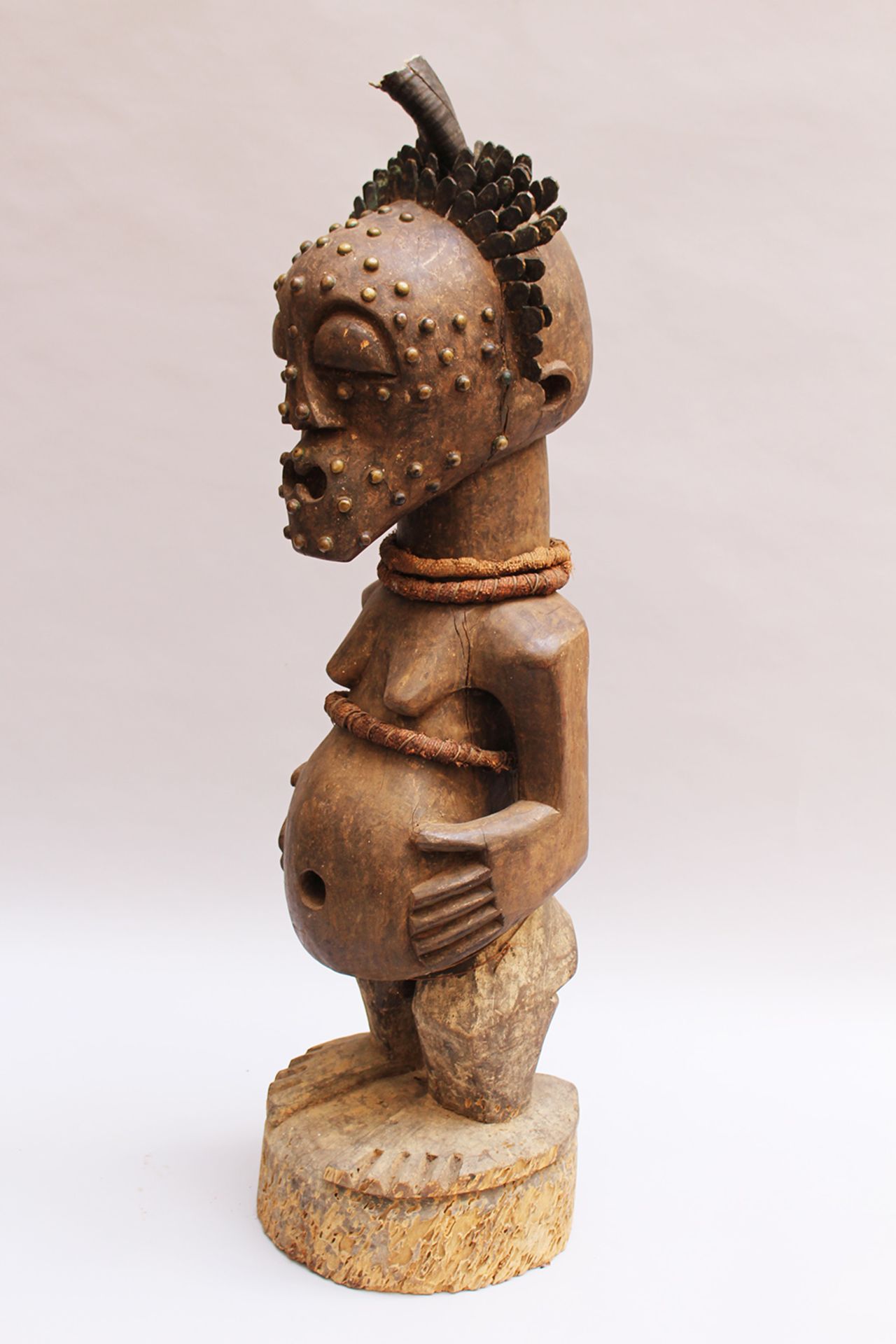 African  Tribal Art sculpture of a standing female on naturalistic integrated base , wood carved wit