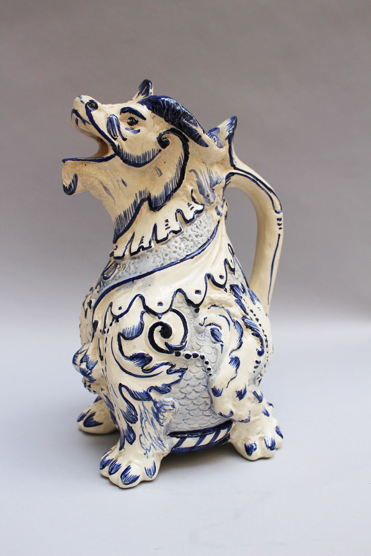 Ceramic jug in Emille Galle (1846-1904)- manner, lion with open mouth and handgrip, painted and glaz