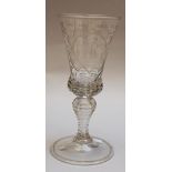 Transparent glass goblet, with one cut and curved central foot, with etched ornament and described “