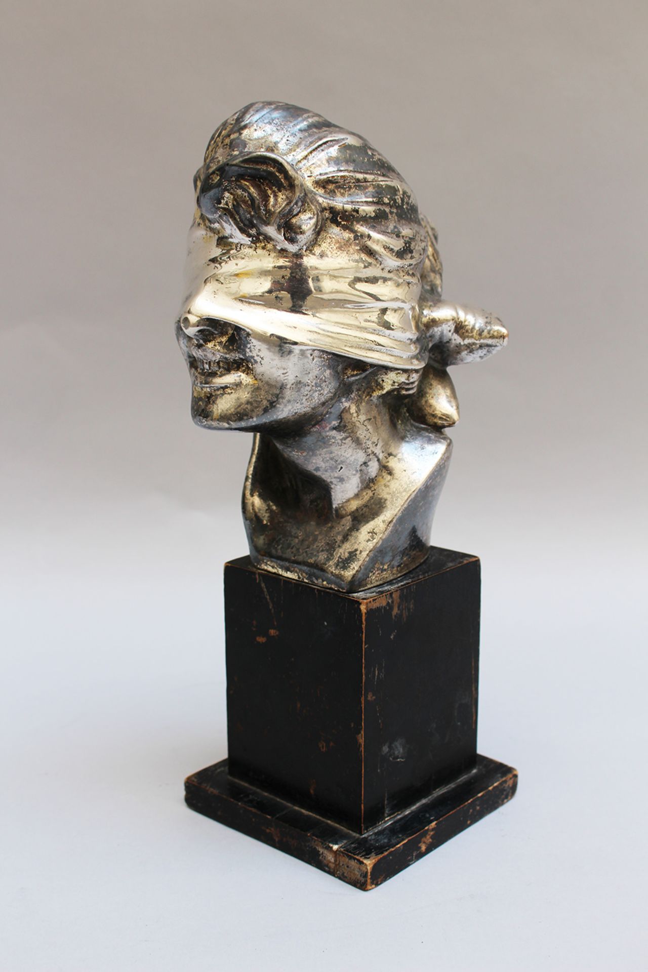 Art Noveau bust of a girl with scarf on the eyes, metal , on ebonised wooden base , signed and