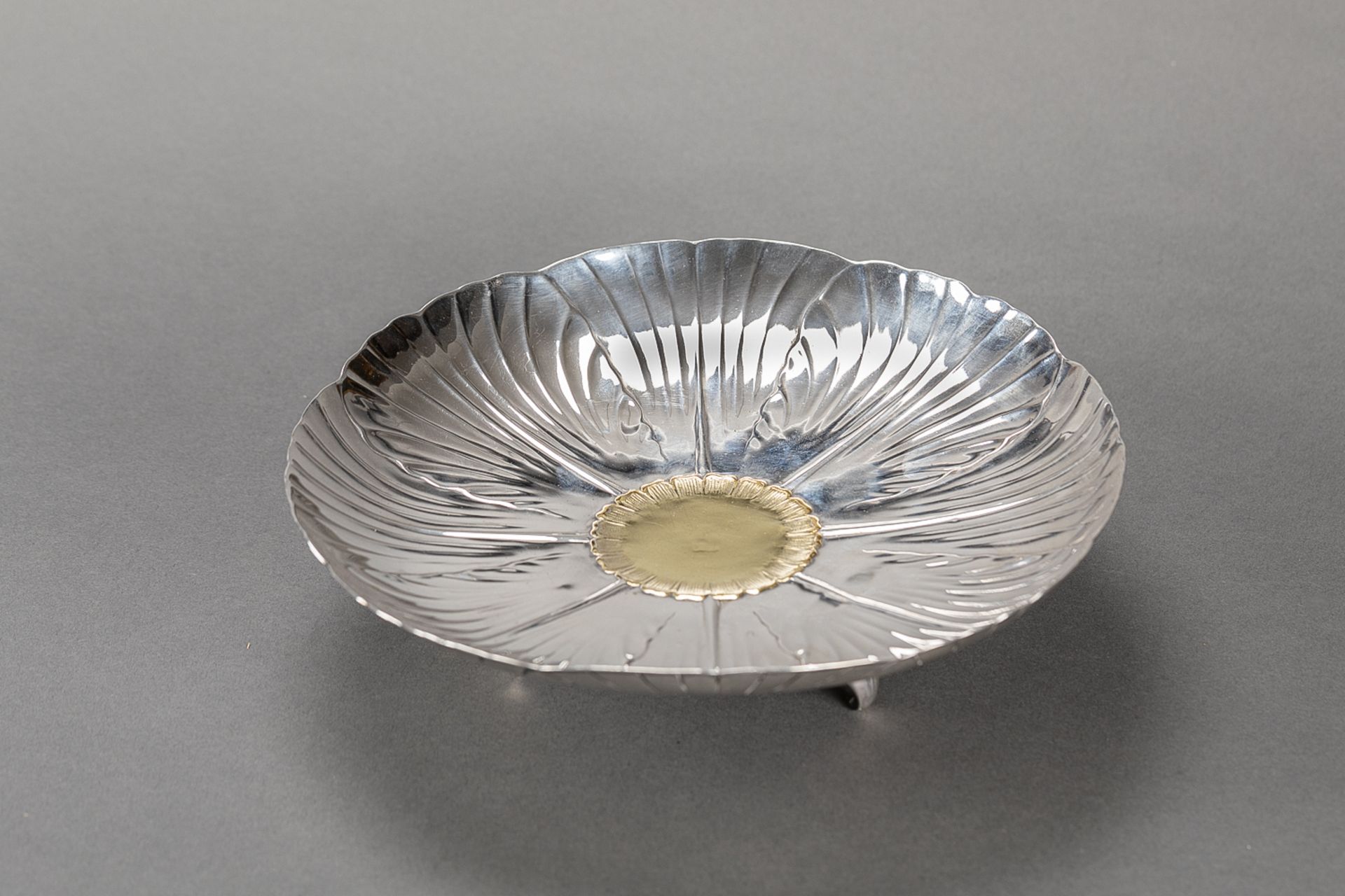 Silver tazza, with three feet; central part vermeille; signed Christofle, numbered 2408, Paris