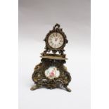 Silver miniature clock, in baroque from , inside gilted, with enamel dial and painting, open