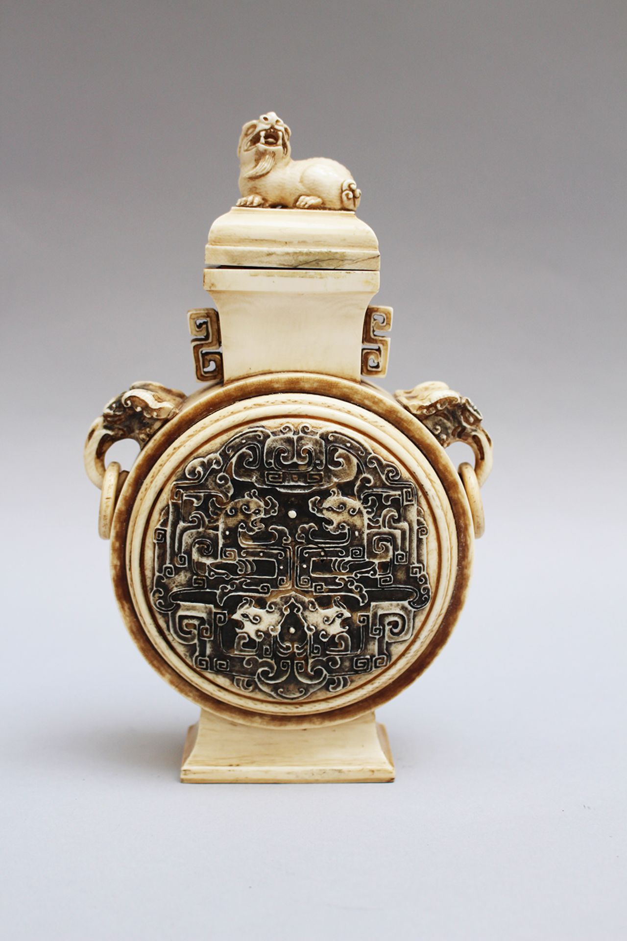 Chinese pilgrim bottle,in traditional shape with two side rings, I . carved with elephants and