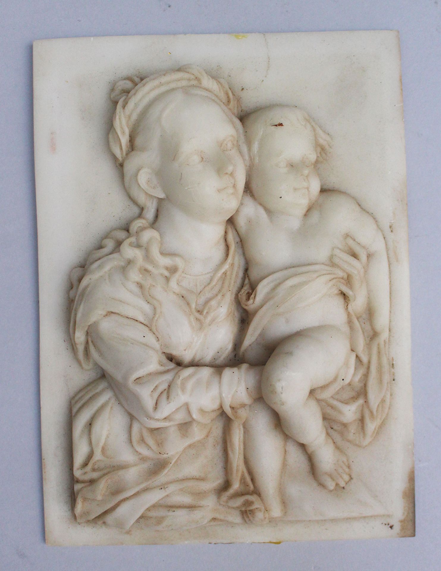 Plaquette with Maria and child in folded cloth, on rectangular plinth, 18x13cm.