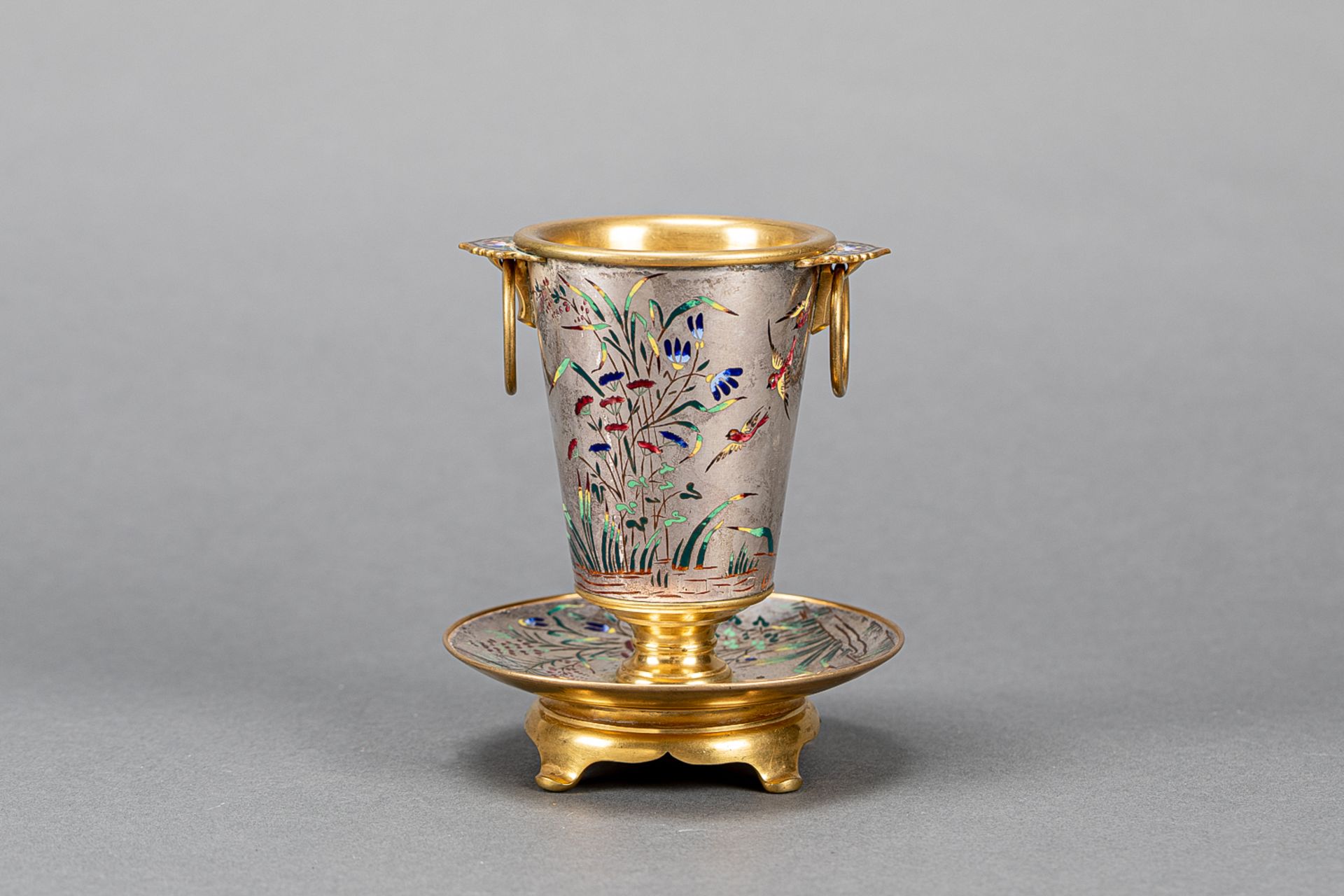 Presentation cup on round base metal silvered and gilded with multi coloured enamels birds and