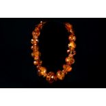 Amber necklace 229g, cut in different large pearls polished, with incrustations.