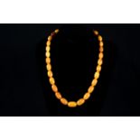 Amber necklace 22g, cutted in different large pearls polished, with incrustations.