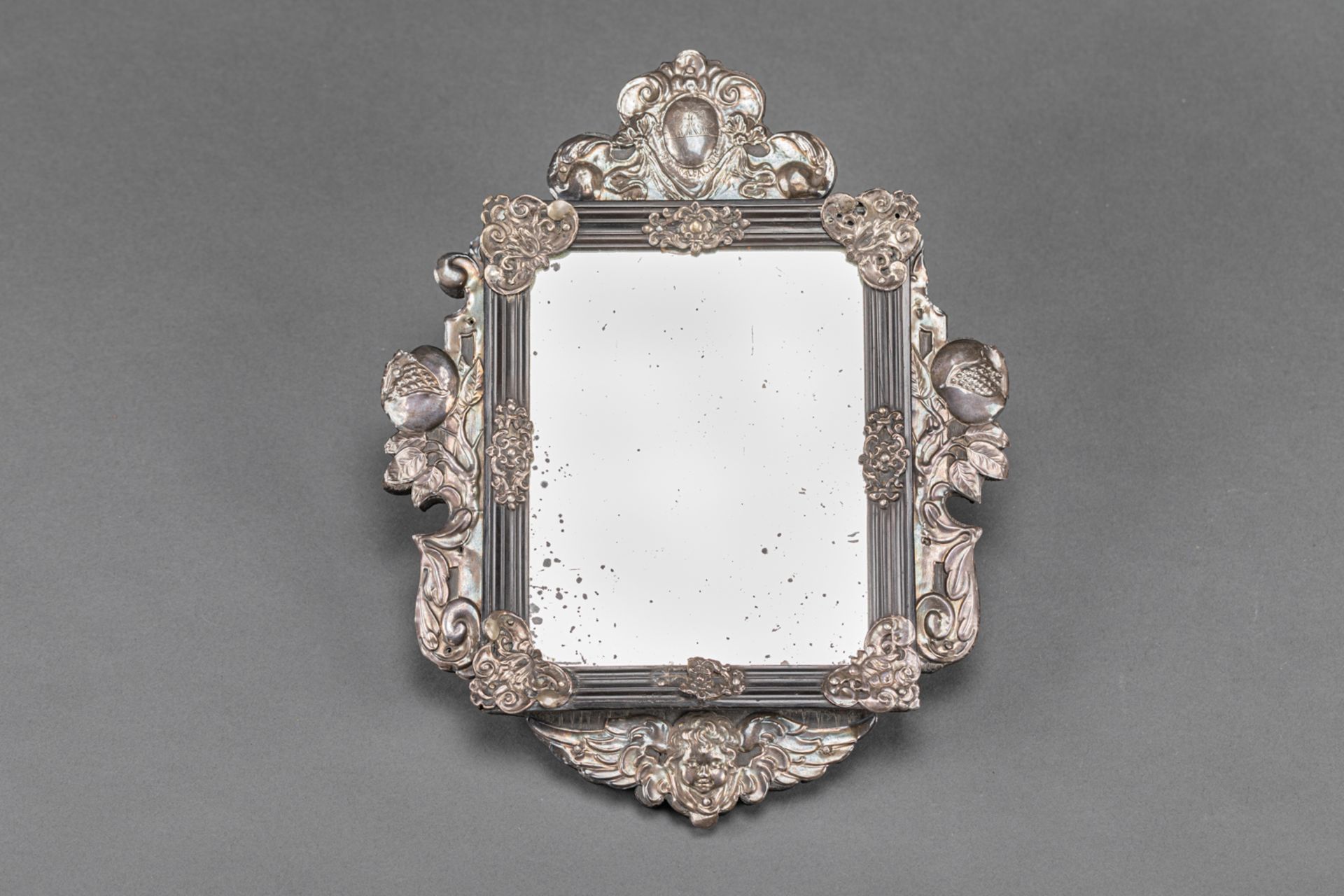 Italian mirror, chased silver ornaments on ebonised wooden frame, with coat of arms with two