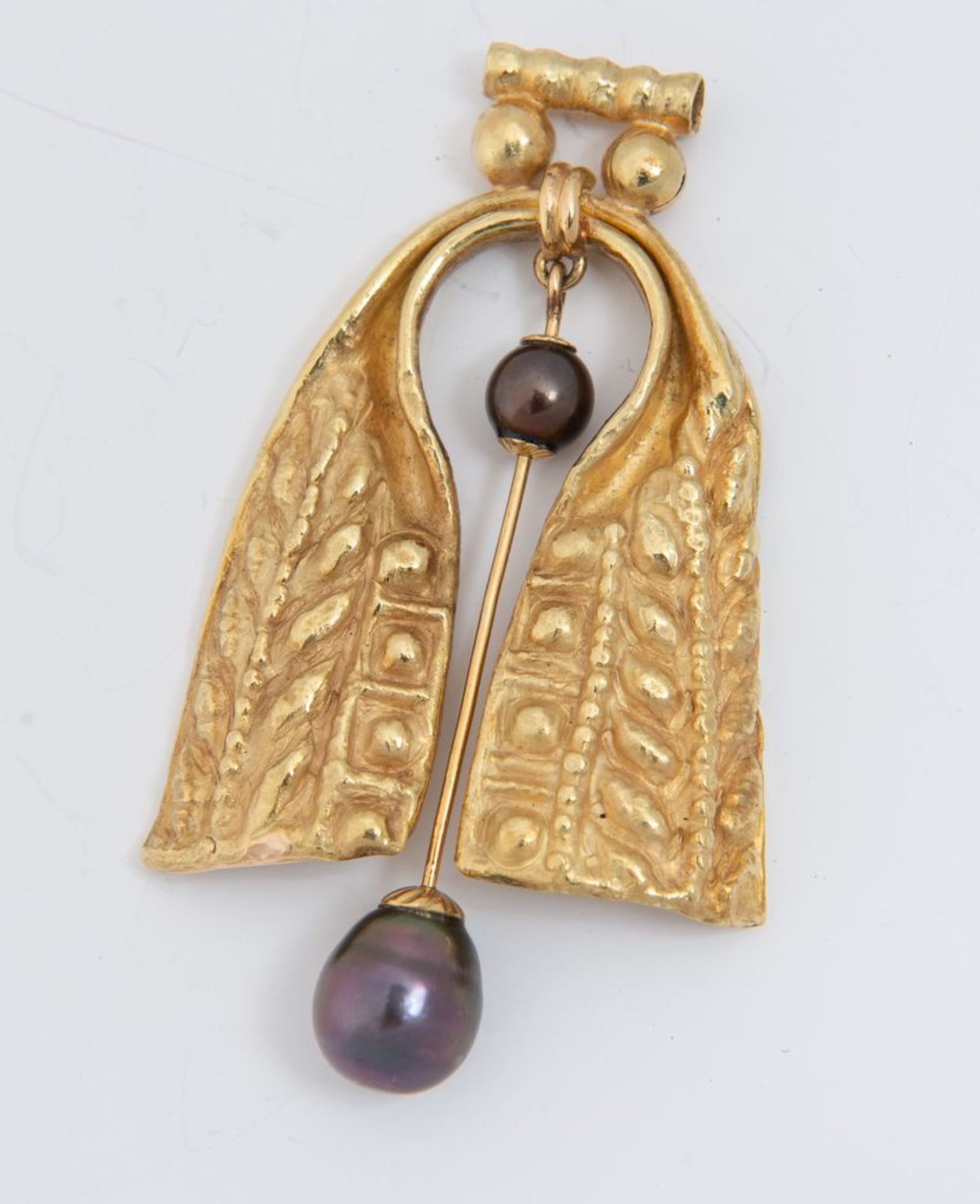 Pendente in oro e perle.
In oro sbalzato e inciso, al centro elemento snodato decorato con due perle - Bild 2 aus 3