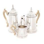 Italian workshop, Silver tea or coffee set, consisting of two teapots and a milk pot, decorated with