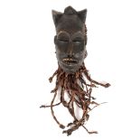 Pwo type mask, exotic wood and banana leaves, representative of the Chokwe tribe, illustrating a god