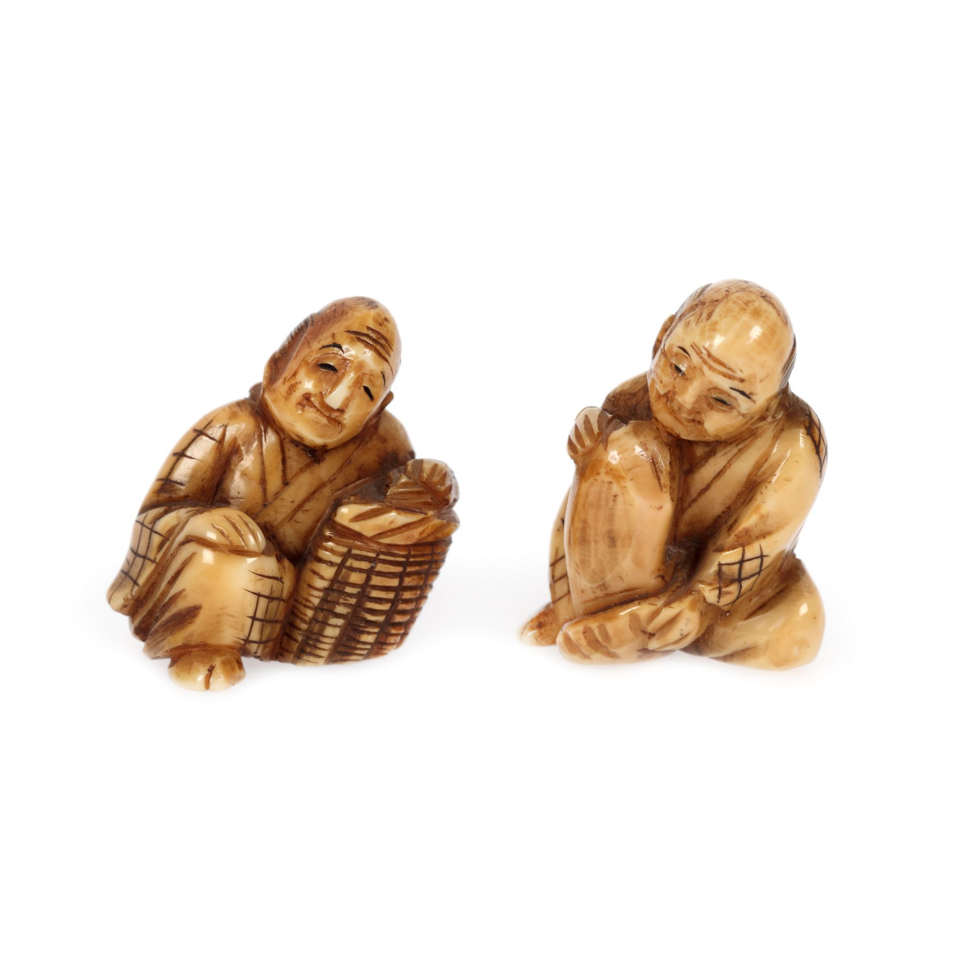 Pair of ivory netsuke, depicting two tormented men, Japan, late 19th century