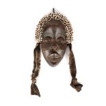 Dan tribal mask, made of exotic wood and decorated with snail shells, Ivory Coast, approx. 1950