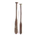 Two exotic wooden oars, possibly Borneo
