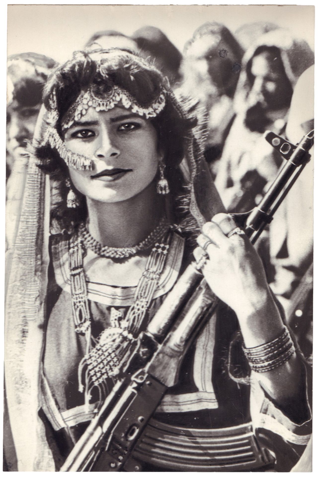 [Soviet–Afghan War]. Photograph "Woman with an assault rifle". Original print. 1986. 11,3x7,6 cm.