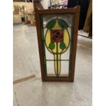 A WOODEN FRAMED ORNATE STAINED GLASS WALL HANGING WITH CHAIN