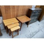 A NEST OF THREE PINE TABLES, OAK OCCASIONAL TABLE AND AN OAK BOOKCASE WITH SLIDING GLASS DOORS