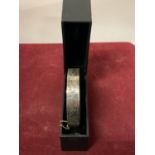 A SILVER BANGLE WITH PRESENTATION BOX