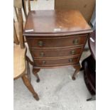 A SMALL MAHOGANY REPRODUCTION CHEST OF THREE DRAWERS ON CABRIOLE SUPPORTS