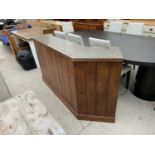 AN OAK BAR UNIT WITH HAMMERED TOP (71" WIDE) - FORMERLY HOUSED IN THE PLAYERS LOUNGE AT THE GAY